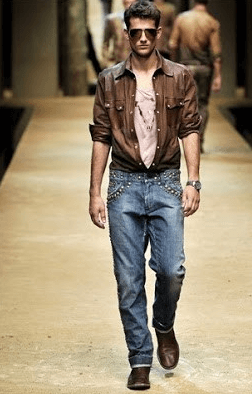 man on runway in jeans and brown shirt